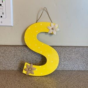 Homemade yellow with white poka-dots and flowers “S” sign